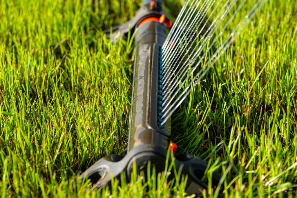 Sprinkler system watering green residential lawn in San Marcos TX